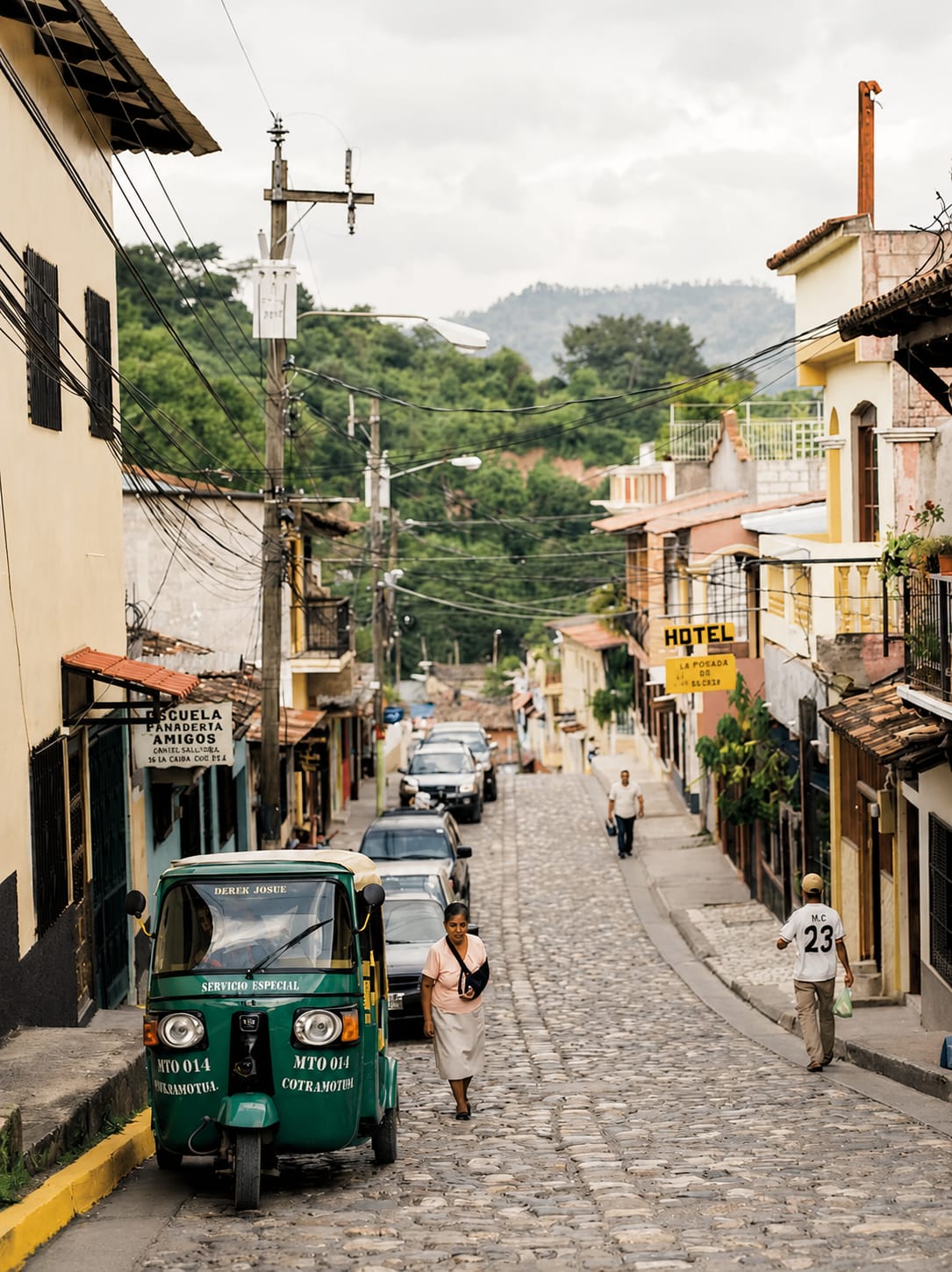 Cobblestone street with a green tuk-tuk in Copán Ruinas