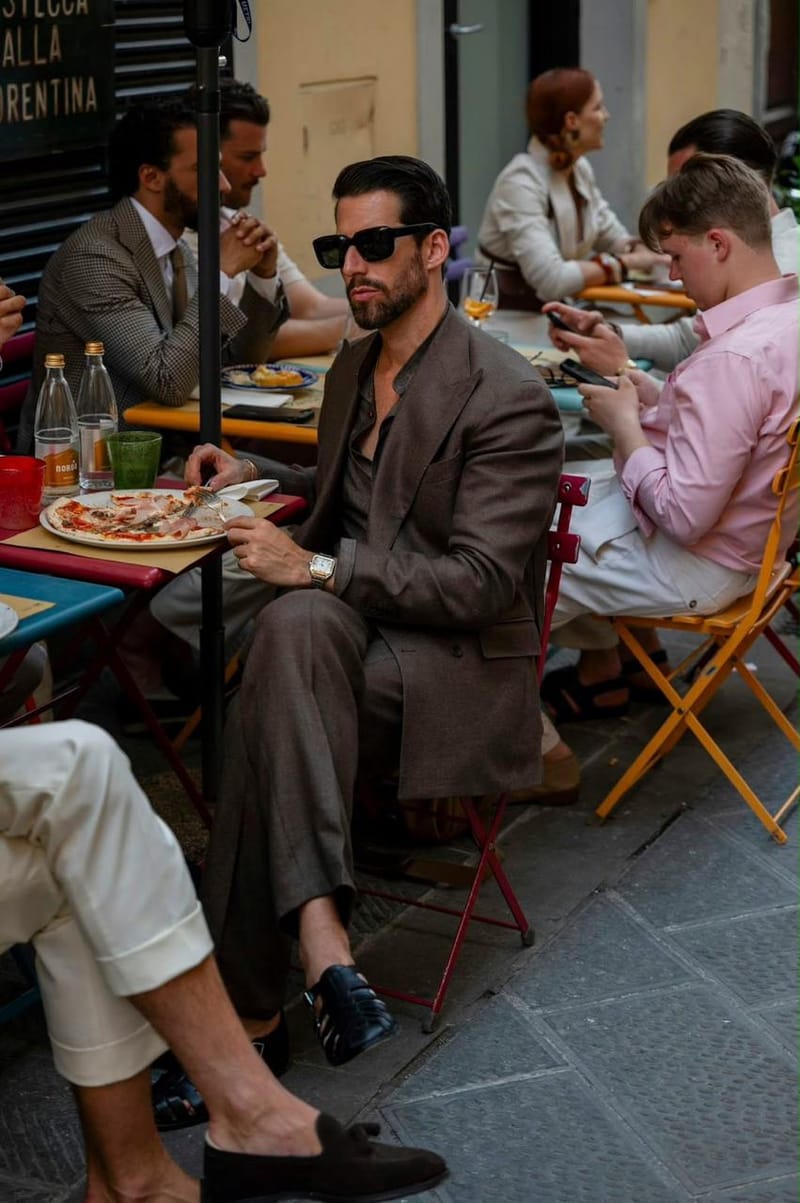 Men in light suits at an outdoor lunch
